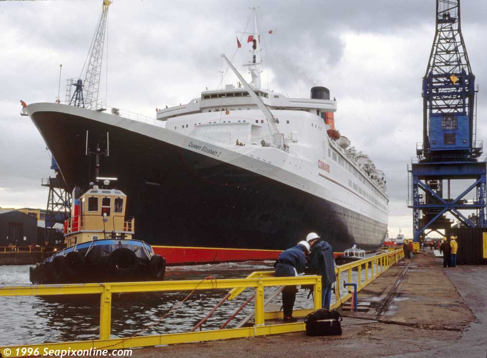 QUEEN ELIZABETH 2 (1969/70327grt/IMO 6725418) assisted by the tug WYEGUARD (1983/60grt, ex-ANTJE. Renamed AFON WEN, HANDFAST) manoeuvring in the A&P drydock in Southampton, England. 1996. Photo by SeapixOnline.com